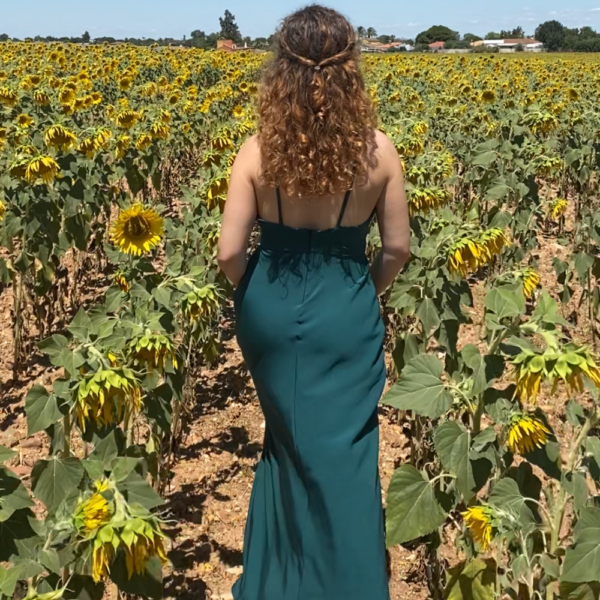 Woman in a green dress with sunflowers